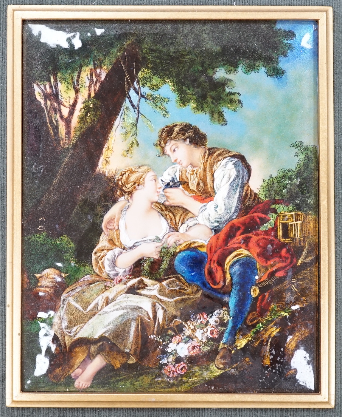 A Limoges enamel plaque, decorated with two lovers wearing 18th century dress before a landscape, housed in a gilt frame, 25cm x 19cm excluding the frame